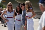 A lucky boy is surrounded by three attractive ladies as an older gentleman frame right takes a gander...with the P-38 Glacier Girl provides a backdrop.